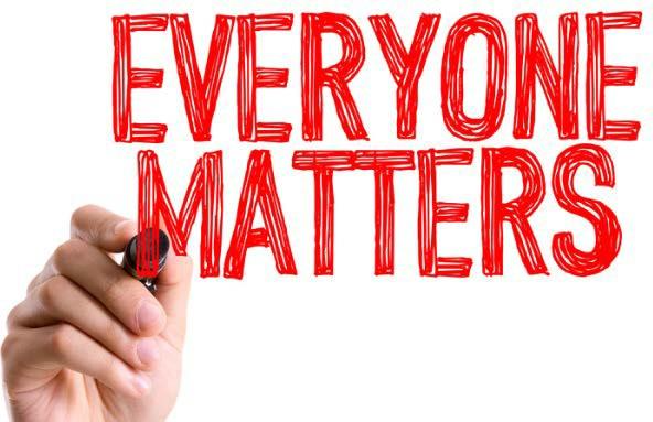 hand writing everyone matters in red marker