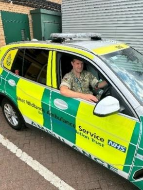 member of the armed forces sat stationary in ambulance vehicle