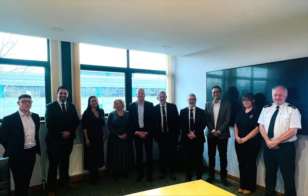 A group photo of men and women in an office