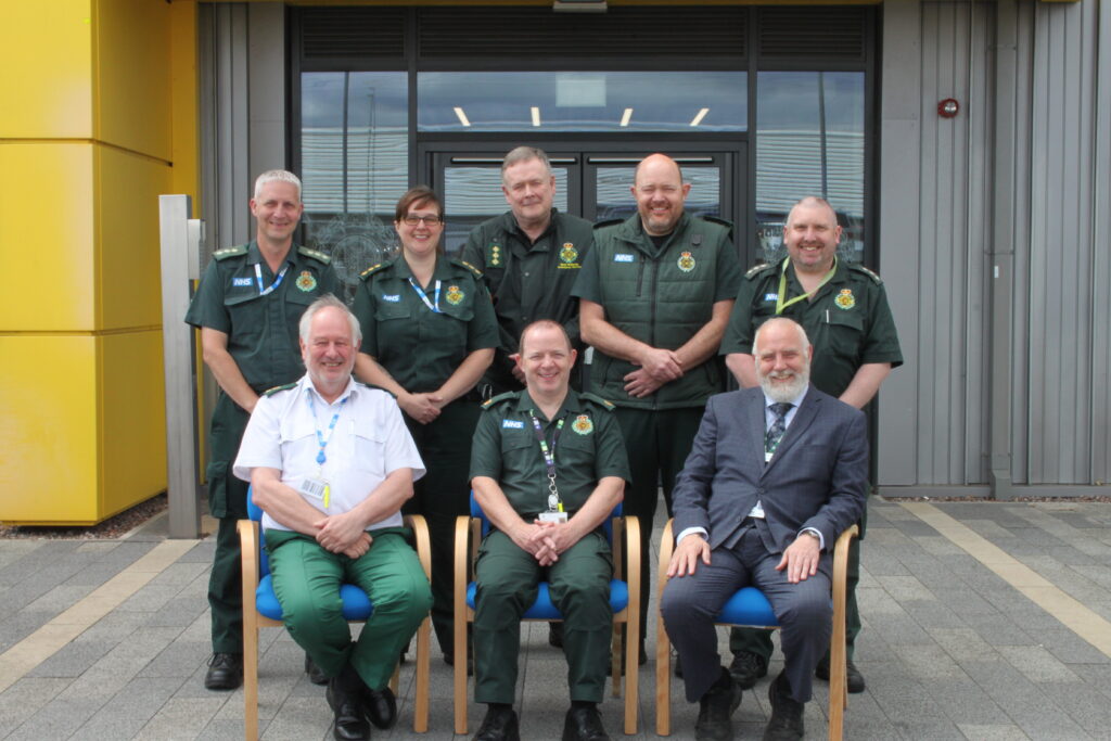A group of tutors from West Midlands Ambulance Service outside a building