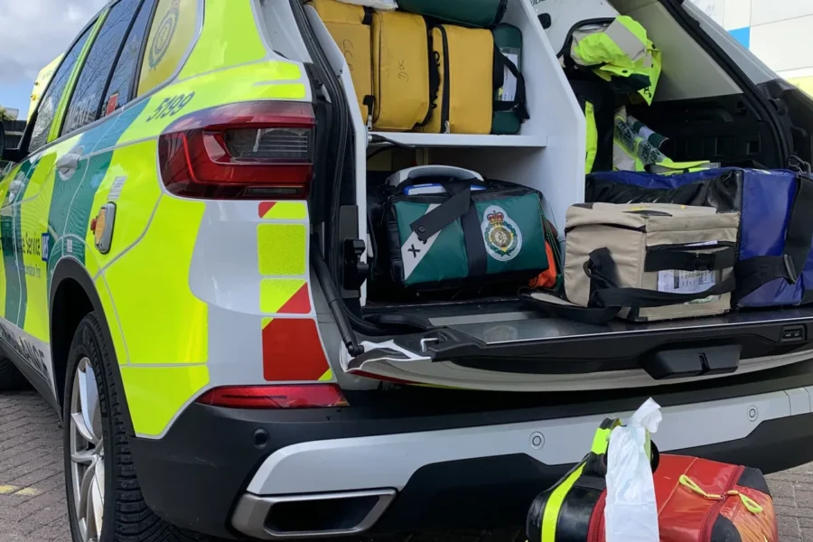 An ambulance car with its boot open showing some equipment on shelving