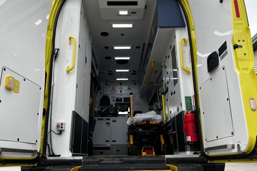 View of the inside of the back of an ambulance with both doors open.