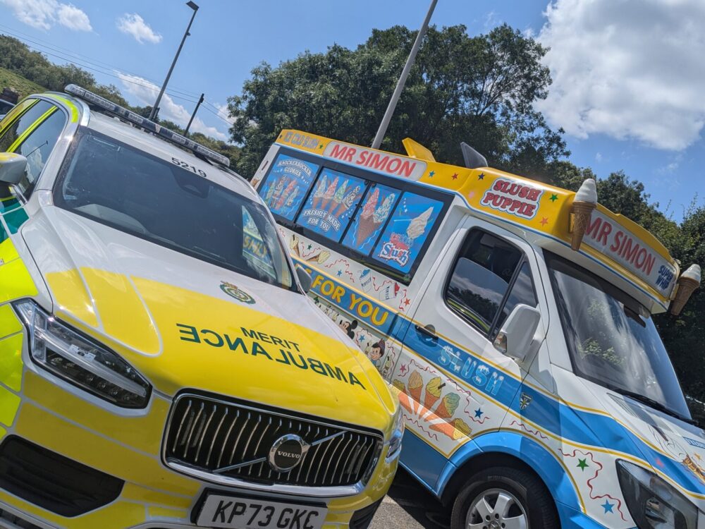MERIT vehicle parked next to an ice cream van on a sunny day