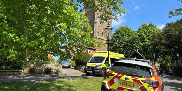 Shipston Community Firs Responder Response Car parked on grass kerb with ambulance in background parked in front of church