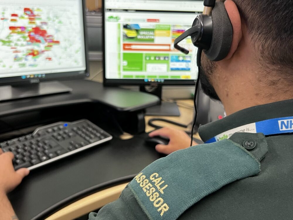 999 call assessor facing control room screens wearing headset