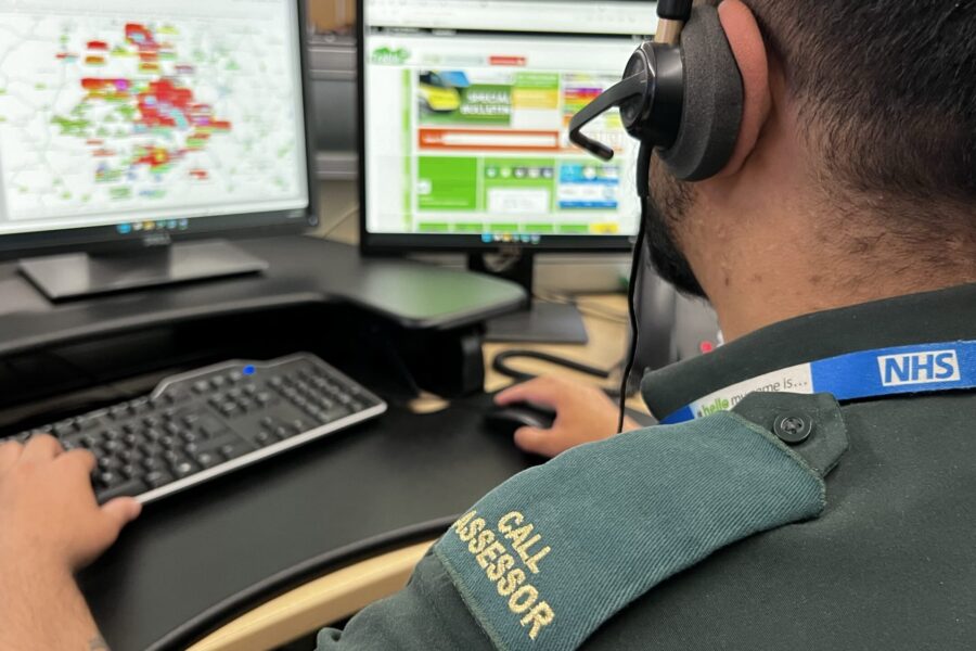 999 call assessor facing control room screens wearing headset - Serious RTC in Edgbaston