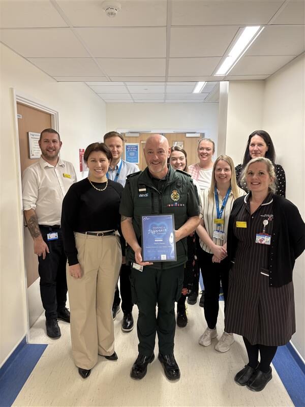 An award presentation taking place at a hospital